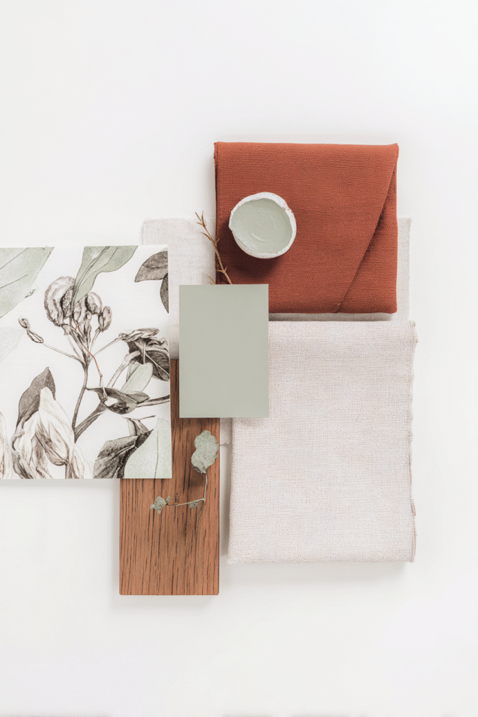 Fabric swatches, patterned paper, and paint sample on a minimal layout for interior design inspiration.